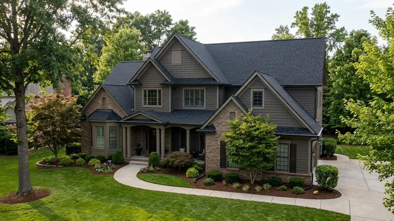 Roofing contractor in Hermitage, TN A beautiful home in Hermitage, Tennessee with a new architectural shingle roof, clean gutters and a neat lawn in warm light