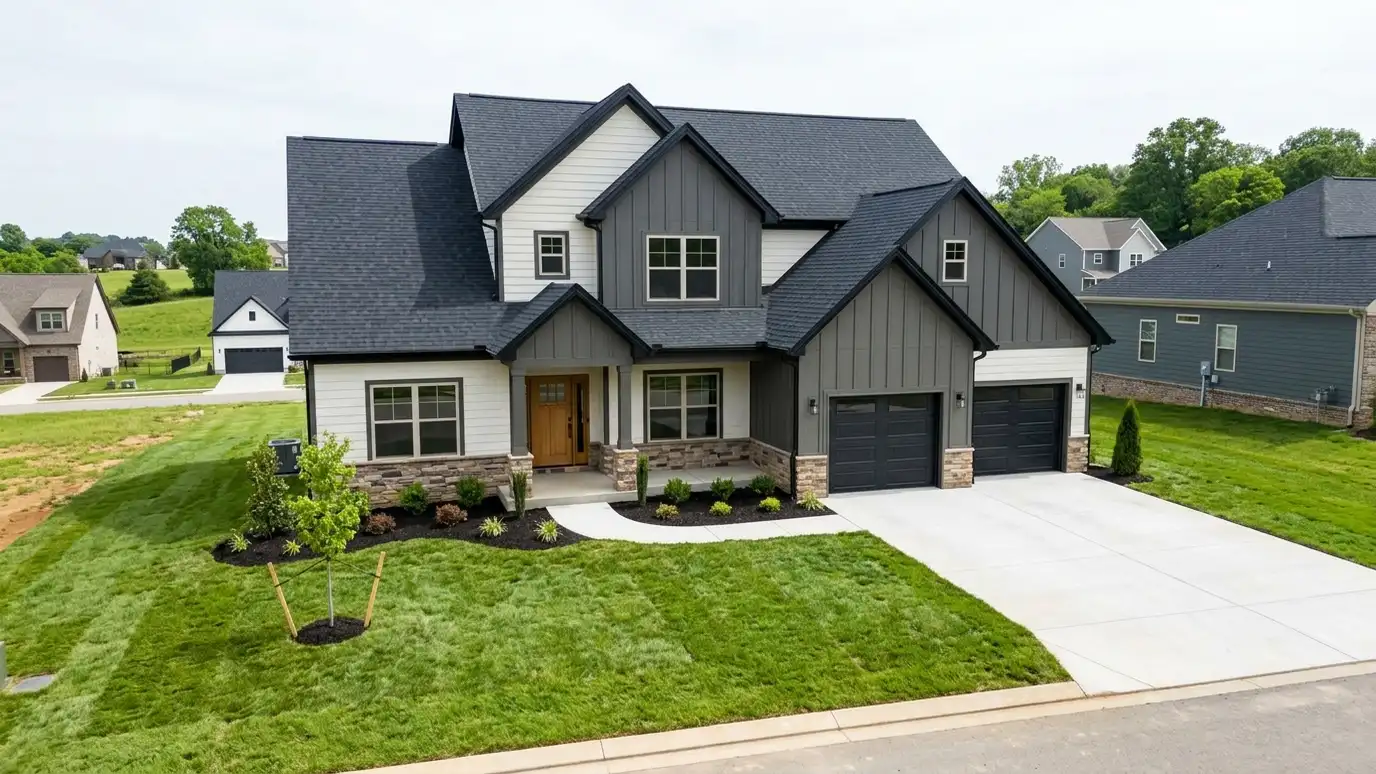 A beautiful home in Spring Hill, Tennessee with a new architectural shingle roof, clean gutters and a neat lawn in warm light